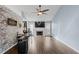 Spacious living room featuring hardwood floors, fireplace, and brick accent wall at 3321 Caleb Sw Rd, Snellville, GA 30039