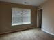 Main bedroom with large window and door to the bathroom at 837 Crestwell Sw Cir, Atlanta, GA 30331