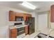 Modern kitchen featuring black appliances and wood cabinets at 6273 Lake Valley Pt, Lithonia, GA 30058