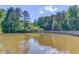 Serene pond with gazebo and boardwalk, surrounded by lush greenery at 6273 Lake Valley Pt, Lithonia, GA 30058