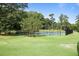 Community tennis courts surrounded by trees at 134 Amherst Nw Pl, Atlanta, GA 30327