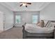 Main bedroom with gray carpet and a ceiling fan at 1576 Silvaner Nw Ave # 21, Kennesaw, GA 30152