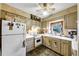 Galley kitchen with white appliances and wood cabinets at 68 Montre Nw Sq, Atlanta, GA 30327