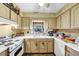 Galley kitchen with white appliances and wood cabinets at 68 Montre Nw Sq, Atlanta, GA 30327