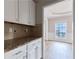 Kitchen features granite countertops and white cabinets at 20 Daniel Creek Ln, Sugar Hill, GA 30518