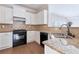 Kitchen with granite countertops and black appliances at 20 Daniel Creek Ln, Sugar Hill, GA 30518