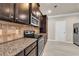 Modern kitchen with dark cabinetry and granite countertops at 2199 Baywood Tree Ln, Snellville, GA 30078