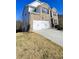 Two-story home with brick and siding, a white garage door, and a sloped driveway at 2770 Blake Towers Ln, Buford, GA 30519