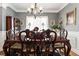 Formal dining room featuring a large table, chandelier, and rich wood tones at 501 Holly Hills Ln, Mcdonough, GA 30252