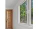 Bedroom with wood door and window overlooking trees at 1840 Pilgrim Mill Cir, Cumming, GA 30041