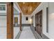 Covered front porch with wooden posts and brick flooring at 1840 Pilgrim Mill Cir, Cumming, GA 30041