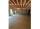 Unfinished basement with framed walls and concrete floor at 3780 Chattahoochee Lot 32 Rd, Cumming, GA 30041