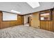 Bright basement area with wood paneling and access to kitchen at 3734 N Camp Creek Sw Pkwy, Atlanta, GA 30331