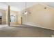 Spacious living room with high ceilings, ceiling fan, and neutral carpeting at 129 Talon Pl, Mcdonough, GA 30253