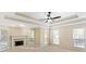 Living room with fireplace, high ceilings, and multiple windows at 129 Talon Pl, Mcdonough, GA 30253