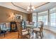 Spacious dining room with bay window and glass-top dining table at 4388 Sleepy Hollow Cv, Lilburn, GA 30047