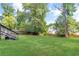 Large grassy backyard with mature trees and privacy fence at 1398 Woodland Ave, Atlanta, GA 30316