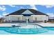 Community pool with a fun spray feature and covered seating area at 516 Vervain Dr, Locust Grove, GA 30248