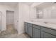 Double vanity bathroom with grey cabinets and marble countertops at 524 Vervain Dr, Locust Grove, GA 30248