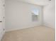Simple bedroom with carpeted floor and a window with blinds at 532 Vervain Drive, Locust Grove, GA 30248