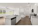 Open concept kitchen with island, granite countertops, and hardwood floors at 532 Vervain Drive, Locust Grove, GA 30248