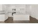 Modern kitchen with white cabinets, granite countertops, and island at 532 Vervain Drive, Locust Grove, GA 30248