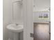 Powder room with pedestal sink and mirror, view into living area at 532 Vervain Drive, Locust Grove, GA 30248