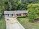Ranch home with gray siding, brick accents, and a driveway at 3569 Briar Dr, Lithia Springs, GA 30122