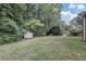 Spacious backyard with a shed, trees, and a partially fenced area at 3569 Briar Dr, Lithia Springs, GA 30122