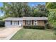 Ranch home with brick and gray siding, a small front yard, and mature trees at 3569 Briar Dr, Lithia Springs, GA 30122