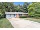 Brick ranch home with a gray accent, driveway, and landscaped lawn at 3569 Briar Dr, Lithia Springs, GA 30122