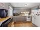 Gray kitchen with white appliances and wood flooring at 3569 Briar Dr, Lithia Springs, GA 30122