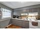 Bright kitchen with gray cabinets, white appliances, and wood floors at 3569 Briar Dr, Lithia Springs, GA 30122
