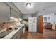 Efficient kitchen, gray cabinets, white appliances, wood floor at 3569 Briar Dr, Lithia Springs, GA 30122