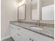 Double vanity bathroom with granite countertop and gold fixtures at 1794 Spring Ne St, Conyers, GA 30012