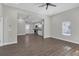 Open living room with kitchen view, hardwood floors, and ceiling fan at 1794 Spring Ne St, Conyers, GA 30012