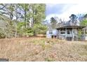 Mobile home with porch, overgrown yard at 1815 S Ola Rd, Locust Grove, GA 30248