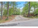 Gravel driveway leading to a wooded property at 2421 Bethel Ne Rd, Conyers, GA 30012