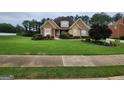 Two-story house with stone accents and manicured lawn at 1995 Evergreen Se Dr, Conyers, GA 30013