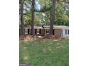 Brick ranch home nestled amongst mature trees at 6470 Connell Rd, South Fulton, GA 30349