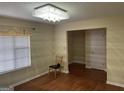 Bright dining room features hardwood floors and a chandelier at 5878 Nell Ln, Ellenwood, GA 30294