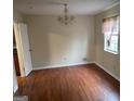 Spacious dining room with hardwood floors and chandelier at 5878 Nell Ln, Ellenwood, GA 30294