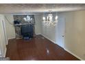 Living room with stone fireplace and hardwood floors at 5878 Nell Ln, Ellenwood, GA 30294