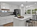 Bright kitchen features white cabinets, an island, and stainless steel appliances at 4505 Cochran Mill Rd, Fairburn, GA 30213