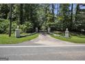 Long driveway leading to a beautiful home nestled amongst lush trees at 4505 Cochran Mill Rd, Fairburn, GA 30213