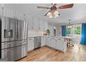 Modern kitchen with white cabinets, stainless steel appliances, and hardwood floors at 30 Allie Dr, Mcdonough, GA 30252
