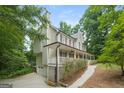 Two-story home with wrap-around porch and attached garage at 267 Wellington Walk, Douglasville, GA 30134