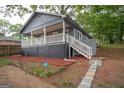 Gray house with white trim, steps, and a landscaped yard at 1889 Vesta Ave, Atlanta, GA 30344