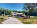 Ranch home with a long driveway and mature trees at 5110 Macland Rd, Powder Springs, GA 30127