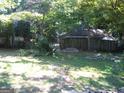 Large backyard with mature trees and partial fence at 960 Stone Mountain Lithonia Rd, Lithonia, GA 30058
